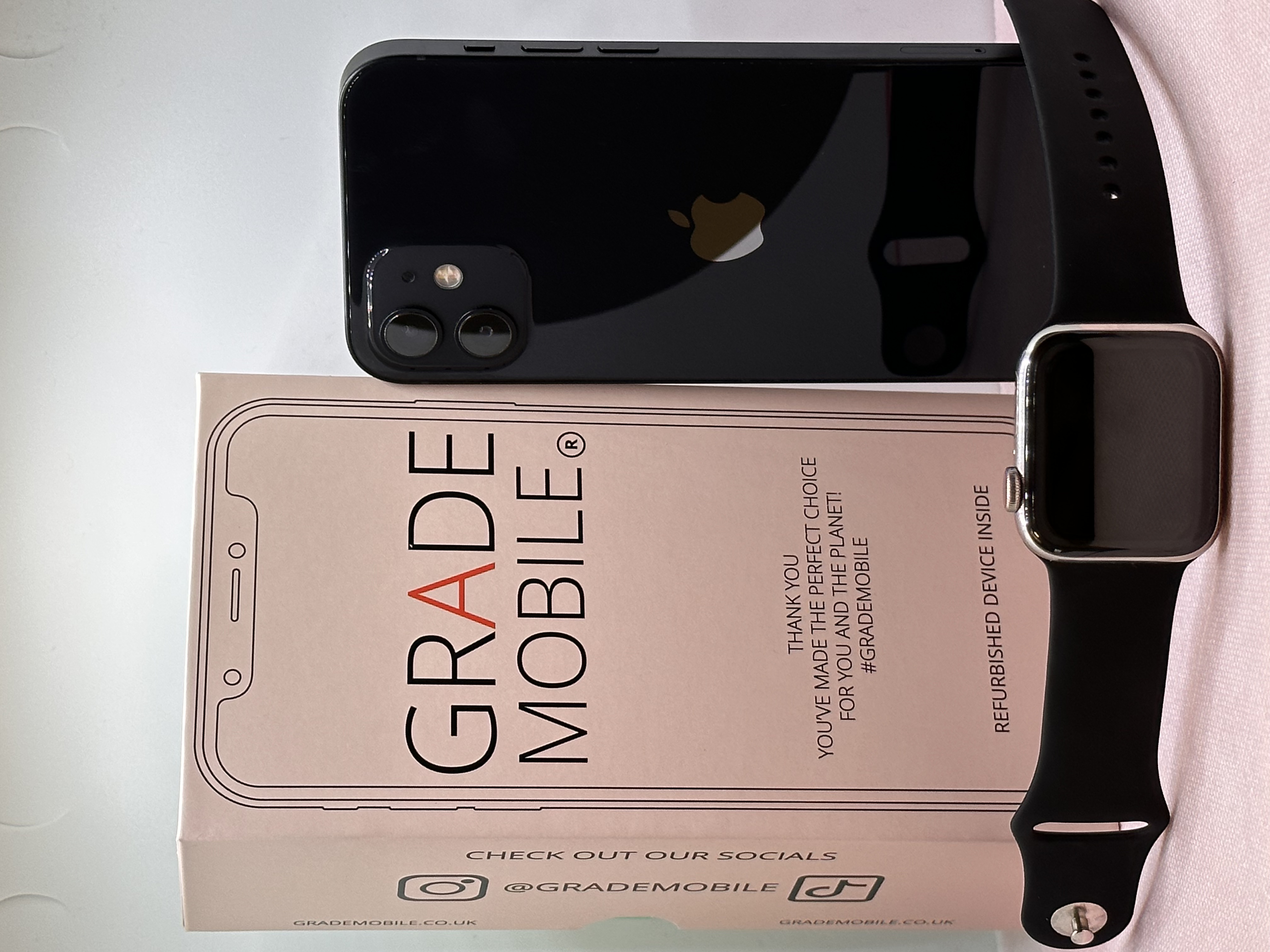 image of an iphone , apple watch and grade mobile packaging